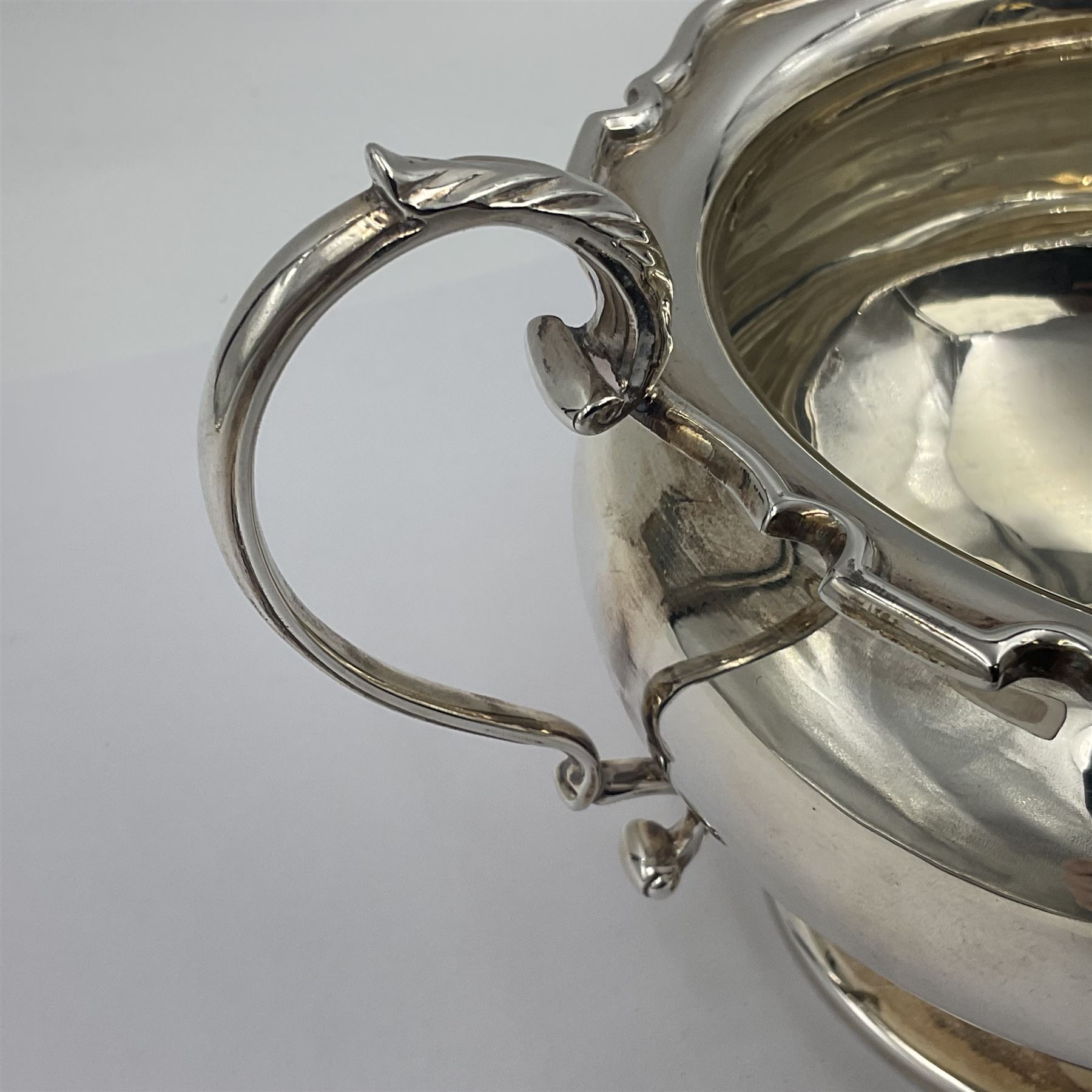 1920s five-piece silver tea service, comprising teapot, coffee pot, hot water pot, twin handled open sucrier and milk jug, each of squat circular form with shaped rim, the teapot, coffee pot and hot water pot each with ebonised handle and finial, the sucrier and milk jug with acanthus capped scroll handles, all upon circular foot, hallmarked R F Mosley & Co, Sheffield 1926 & 1927, tallest H24cm