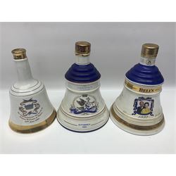 Bells, Scotch whisky, in five Wade ceramic decanters, together with Irish Mist  in novelty decanter, an empty Lambs Navy Rum decanter and similar items, of various content and proof, (11)