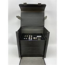  A large carry case opening to reveal five fitted trays containing a selection of assorted items, including various cufflinks, key rings, atomisers, card holders, photo frame, corkscrew, bottle opening, a number of desk clocks, calculators, pen holder, etc.   