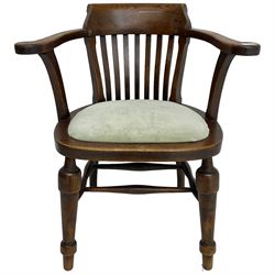 Early 20th century oak smoker's bow armchair, tub-shaped back with scrolled arm terminals, upholstered seat, on turned front supports united by swell-turned stretchers 