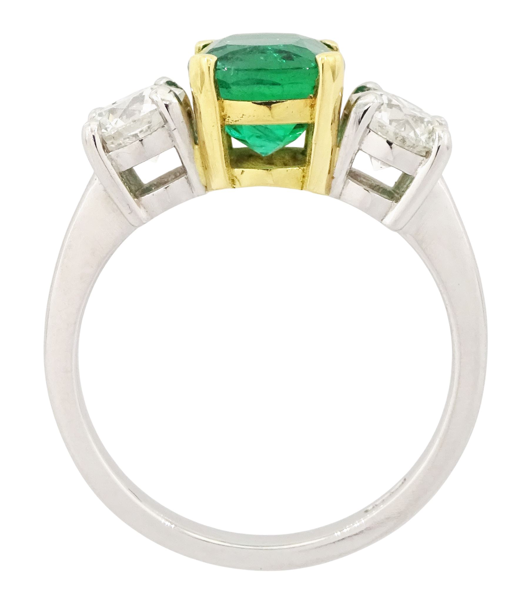 Platinum emerald and diamond three stone ring, single cushion cut emerald of approx  1.85 carat, set with a single round brilliant cut diamond either side, hallmarked, total diamond weight approx 1.20 carat