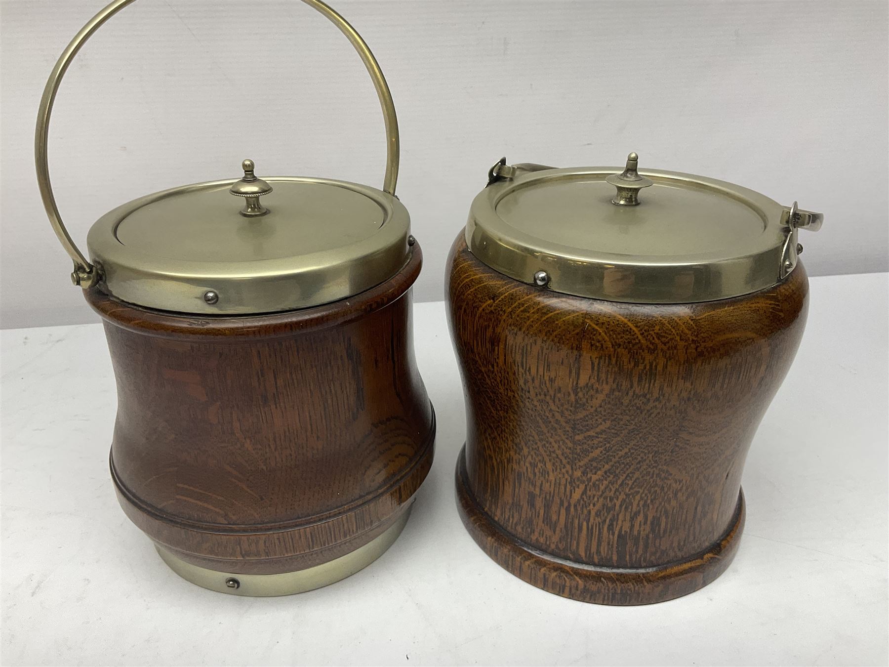 Five early 20th century biscuit barrels with silver-plated mounts, one made from Mahogany from HMS Hindustan