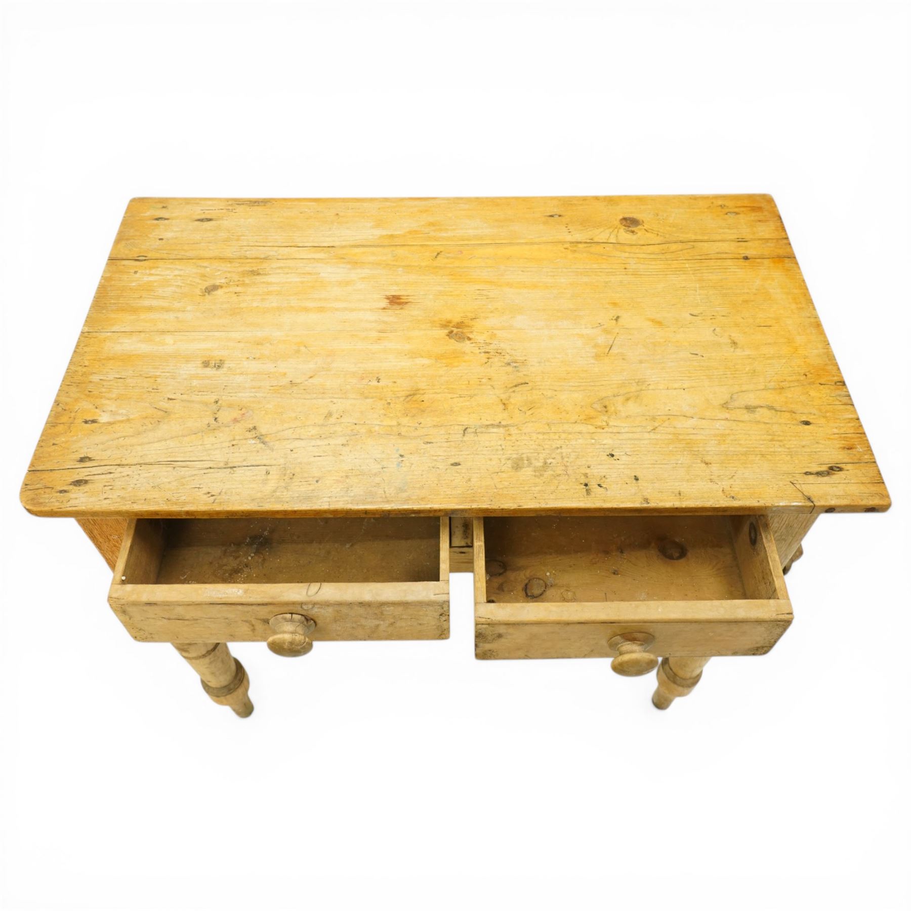 Victorian stripped pine table fitted with two drawers, supported on turned supports