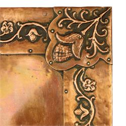 Arts and Crafts copper mounted coffee table, rectangular top with embossed foliate border and stylised corner motifs, studwork detail, on cylindrical supports united by pierced shaped stretcher with applied flowerhead bosses