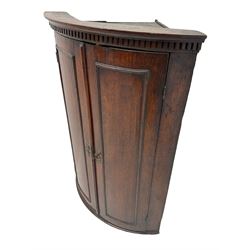 George III oak cylinder corner cupboard, dentil cornice over two doors enclosing three shelves