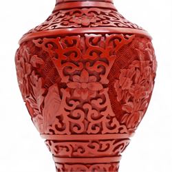 Three Chinese red and black cinnabar lacquered vases, together with three metalware examples, possibly 19th century Islamic, comprising vase, cup and covered vessel with floral handle; and a carved soapstone pig (7)
