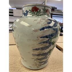 17th century Transitional period Chinese Wucai vase and cover, of baluster form, the body painted with ladies upon a terrace, and figures upon horseback and attendants within a fenced garden, the domed cover with knop finial painted with boys at play, H37cm
