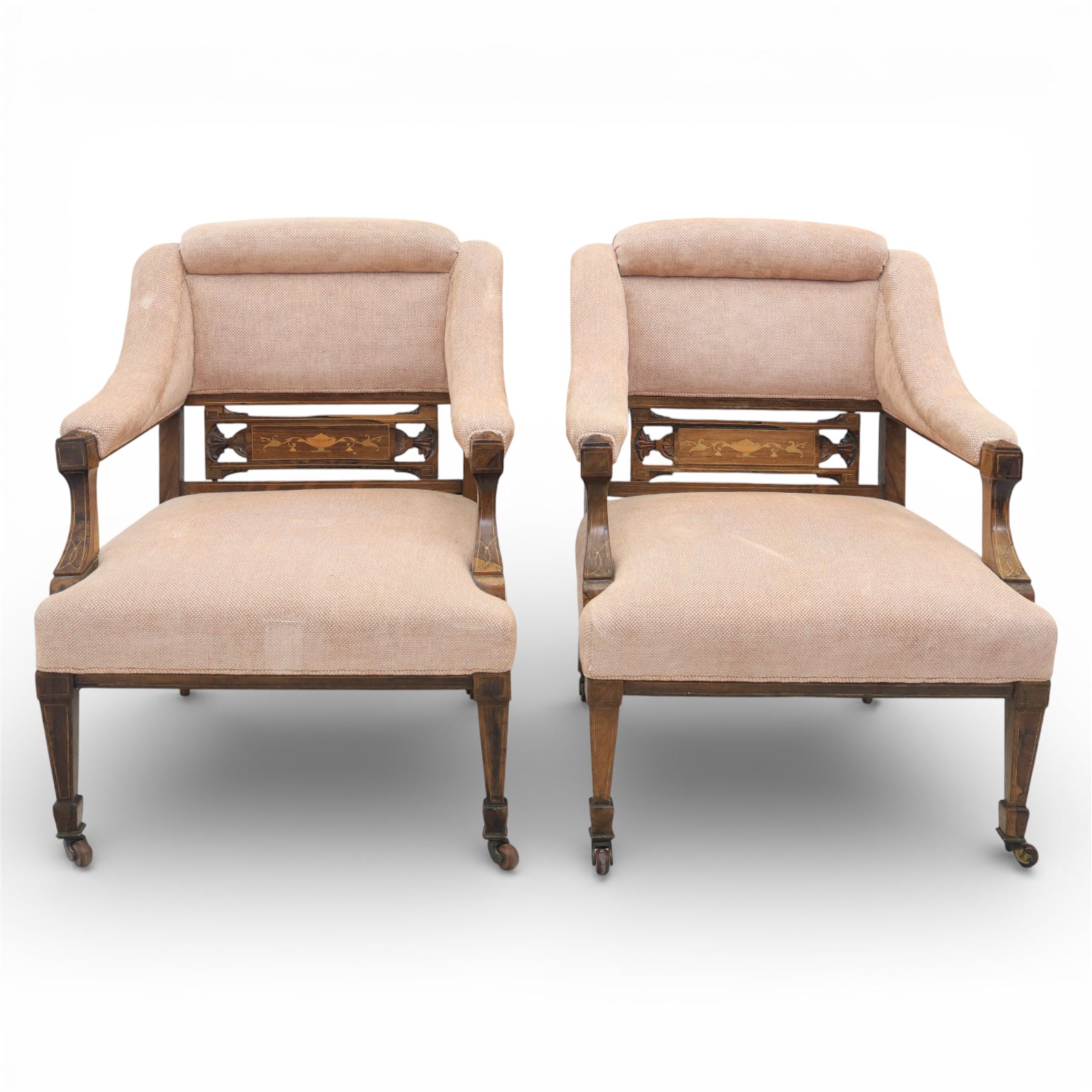 Quality Edwardian seven piece inlaid salon suite, comprising three seater settee, pair of arm chairs and four chairs with pierced splat backs, upholstered in pale pink fabric, inlaid with flowering urns, upon tapering legs with spade feet and castors