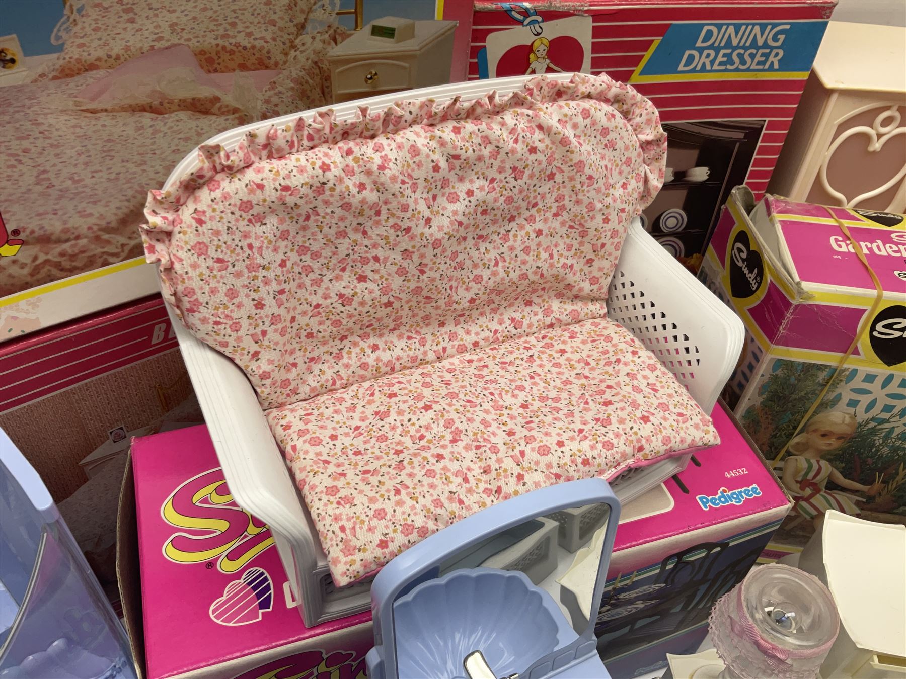 Sindy - furniture and accessories comprising dining suite with separate dresser; two beds; Garden Set; Music Centre; all  boxed; three-piece bedroom suite; settee; Hostess Trolley; two coffee tables; and four-piece bathroom suite including shower cubicle