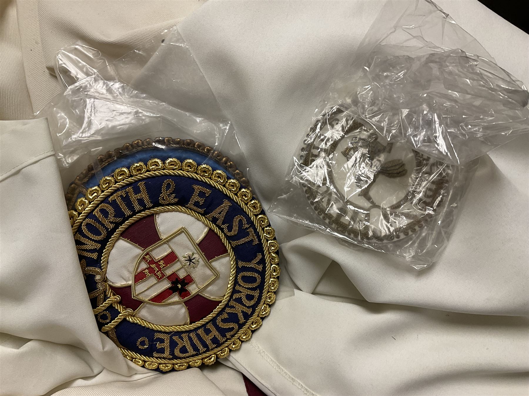 Masonic regalia, including sword, kid leather gloves and apron, Order of Holy Wisdom high priest mitre, etc, contained within briefcases and boxes 