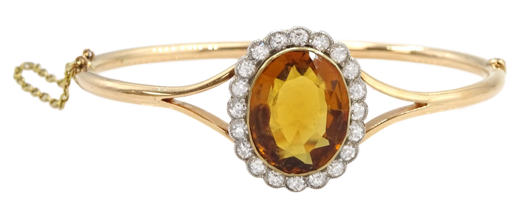 Early 20th century 15ct rose gold oval citrine and milgrain set old cut diamond hinged bangle, total diamond weight approx 1.10 carat