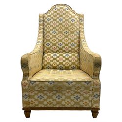 Spanish high back throne armchair, arched cresting rail over scooped arms, upholstered in gold and ivory patterned fabric, on a pitch pine base with spade feet