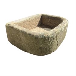 19th century hewn sandstone trough of D shaped form, in weathered finish