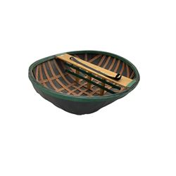 Coracle boat, comprised of woven planks and waterproof covering with single plank seat and strap