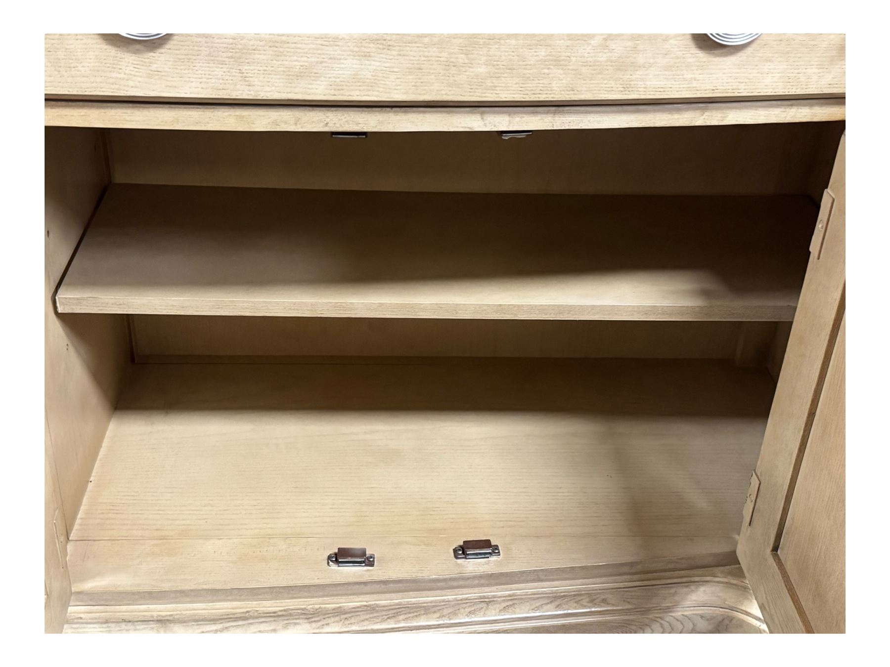 Brunswick - washed oak finish illuminated display cabinet, upper section with four glass-panelled doors enclosing glass shelving, base fitted with two drawers over four paneled cupboard doors, each fitted with distinctive round metal handles, raised on plinth base