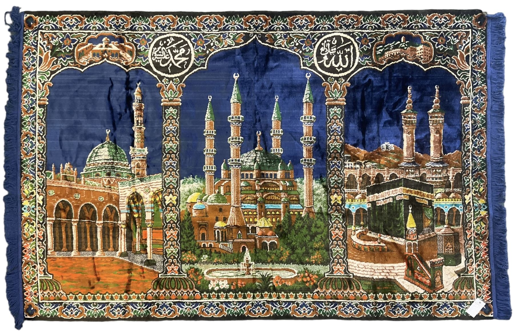 Indigo ground family prayer rug, depicting Masjid al-Haram in Mecca within floral design borders 