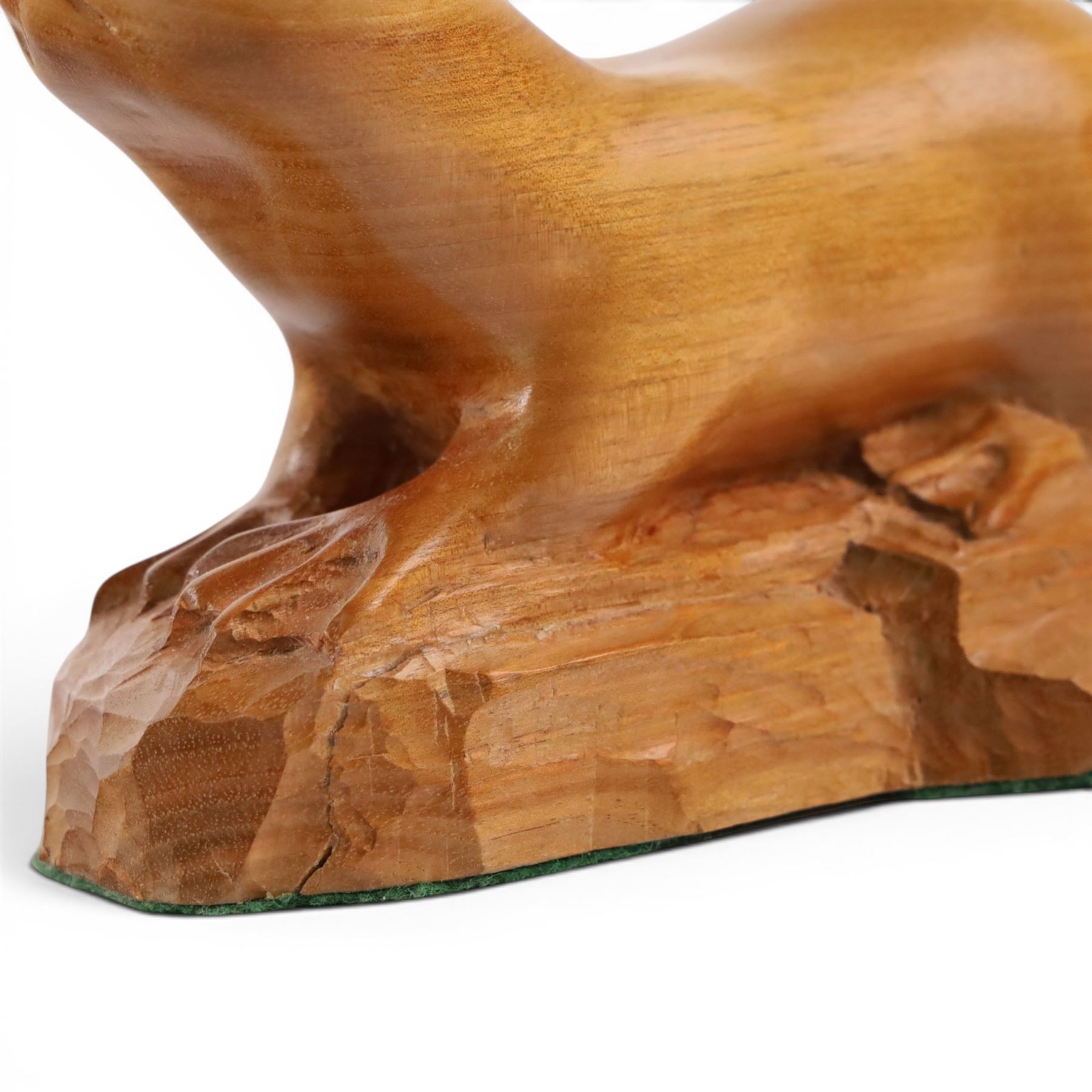 20th century walnut carvings, the first modeled as a wren, the second an otter, H  Two Yorkshire style walnut carvings, of a wren and otter, otter H10cm