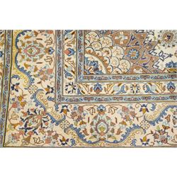 Central Persian Nain hand-knotted carpet, ivory field with central radiating medallion with pendants, issuing an all-over design of scrolling vines, palmettes, and floral sprays within confirming spandrels, framed a complimentary foliate border flanked by multiple guard stripes, with cotton fringe ends 