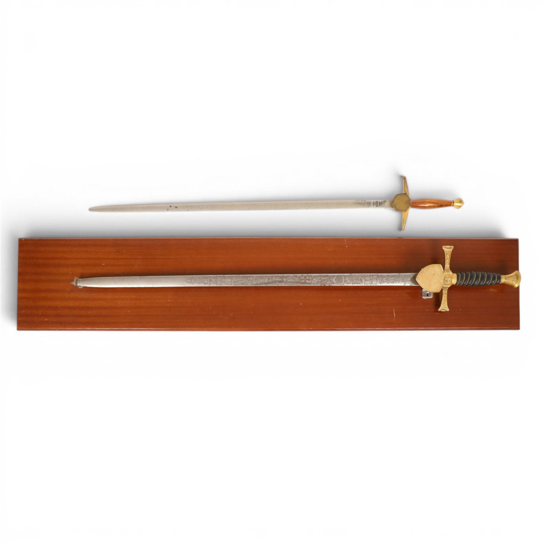 Wilkinson Sword, with 76cm double edge blade, etched with makers name and decoration, wooden grip, brass guard and hilt, together with another sword