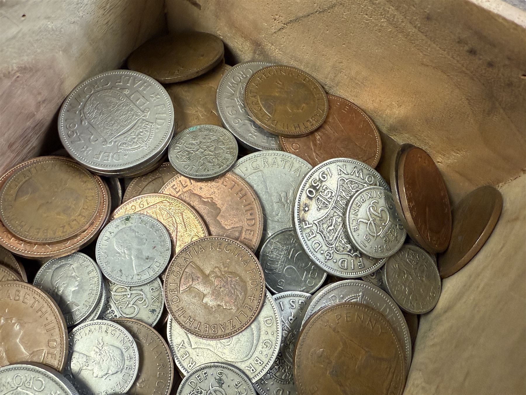 Approximately 115 grams of Great British pre-1947 silver coins, and further pre-decimal coins, housed in a miniature carved camphor wood chest