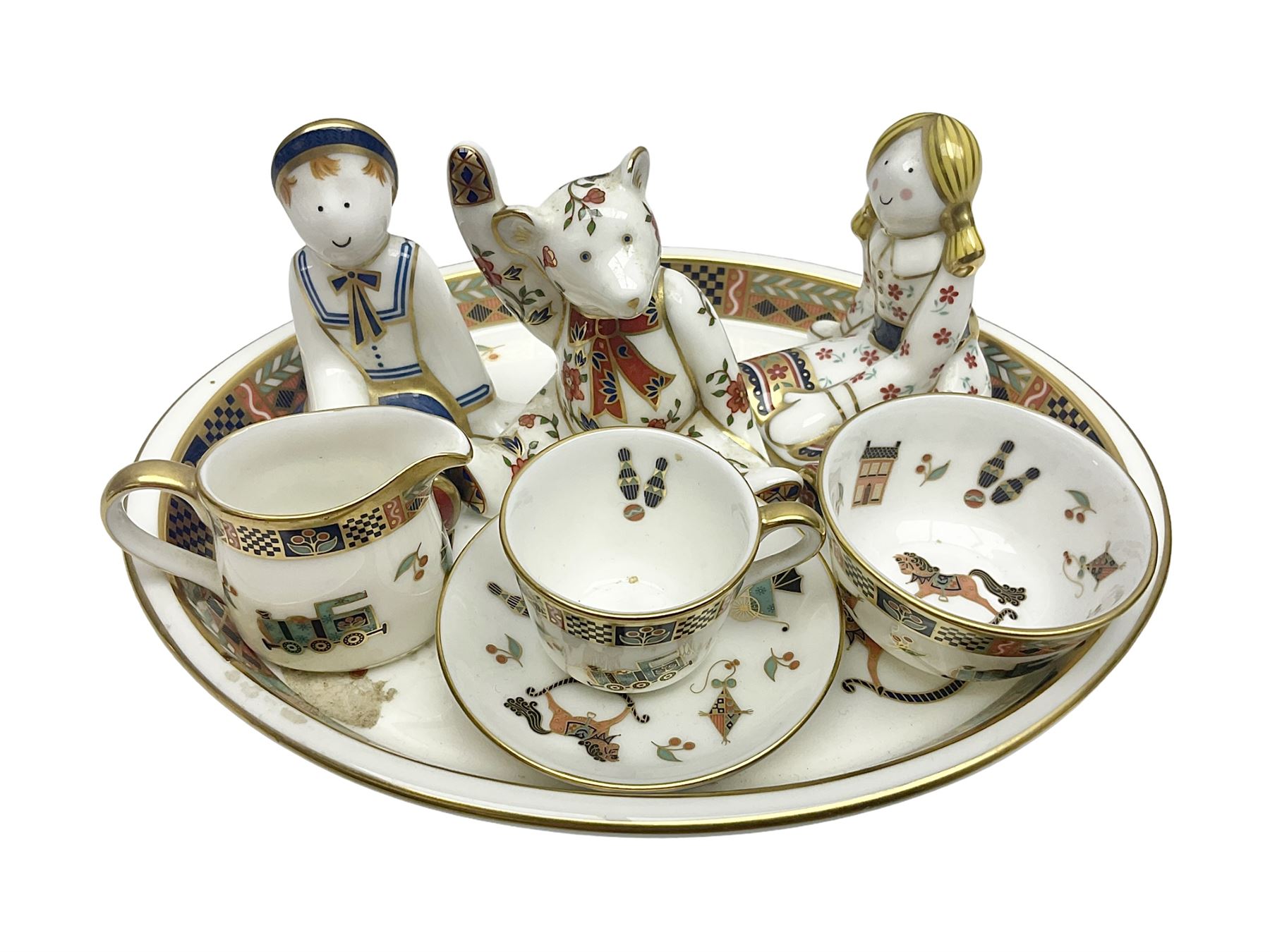 Royal Crown Derby Treasures of Childhood cabaret set, comprising tray, milk jug, sucrier, teacup and saucer, together with two Royal Crown Derby Treasures of Childhood paperweights Fleur and Ragdoll Sailor and Teddy bear paperweight, all paperweights are without stoppers