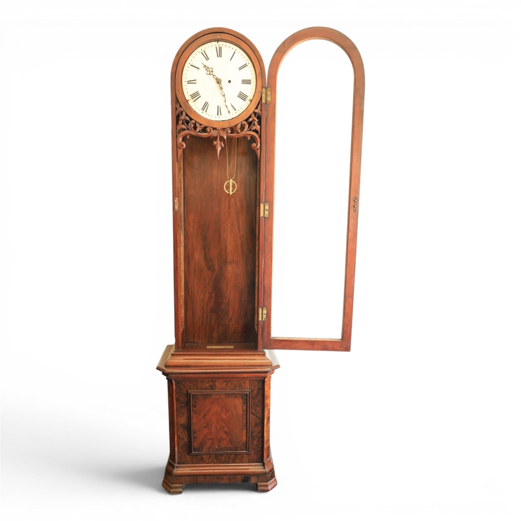 Late 19th century Vienna walnut regulator wall clock, arched glazed case with moulded cornice and figured walnut veneers, circular enamel dial with Roman numerals and pierced hands, carved foliate fretwork beneath the dial, single pendulum movement with brass weights and glazed lower section