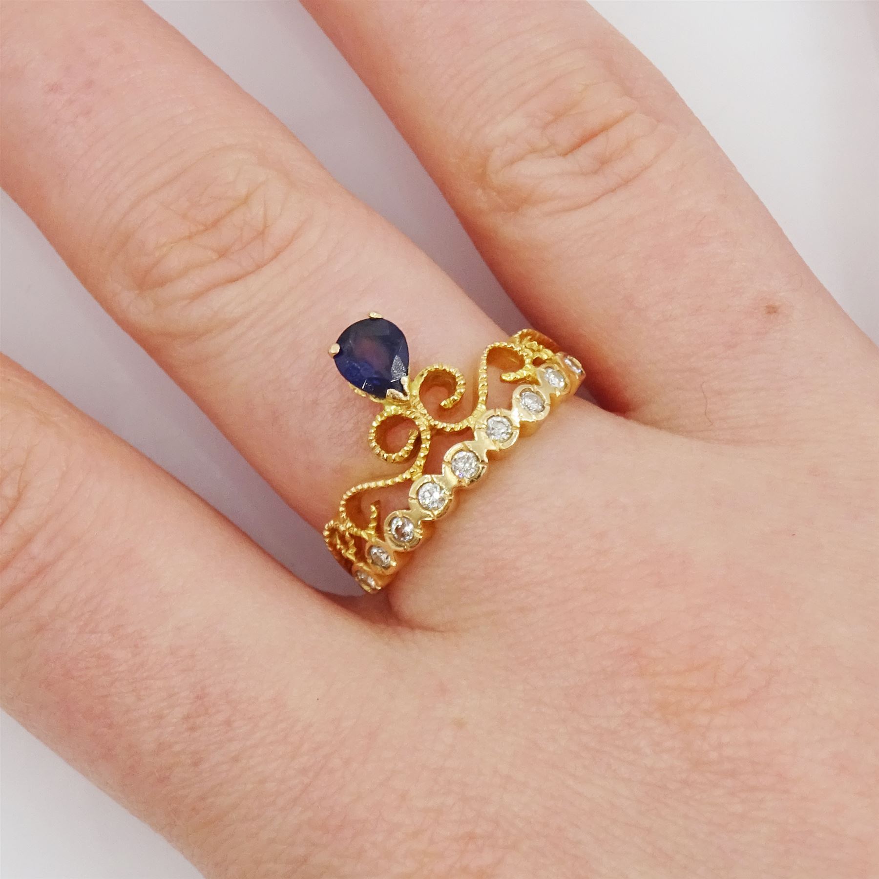 18ct gold pear cut sapphire and nine stone round brilliant cut diamond openwork ring, stamped 750