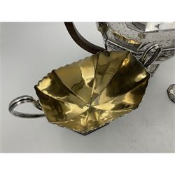 Victorian silver four piece tea service, comprising teapot, teapot stand, twin handled open sucrier and milk jug, each of octagonal form with foliate bud border and engraved decoration including crest to canted panels, and vacant panels, the teapot with ivory finial to the hinged cover and later wooden handle, hallmarked Edward Barnard & Sons Ltd, London1896, teapot including finial H15cm, milk jug including handle H16cm, teapot stand W11.5cm

This item has been registered for sale under Section 10 of the APHA Ivory Act