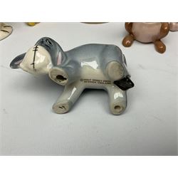 Seven Beswick Winnie the Pooh figures, comprising Pooh Bear, Tigger, Piglet, Kanga, Mr Rabbit, Owl, and Eeyore, together with two Royal Doulton Winnie the pooh Christmas Collection figures, 'The Most Perfect Tree in all the Wood', and 'Christopher Robin Dresses the Tree', (9)  