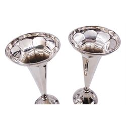 Pair of early 20th century silver trumpet vases, of tapering faceted form, upon spreading filled bases, hallmarked Thomas Edward Atkins, Birmingham 1911, H23cm