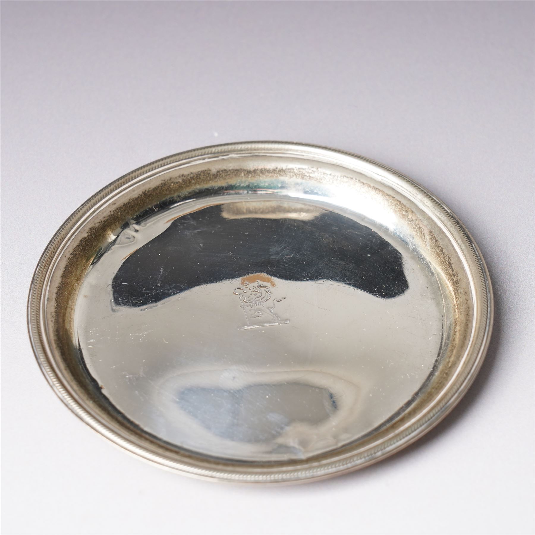 Early 19th century silver wine funnel with small circular stand engraved with a crest, makers mark on stand PG