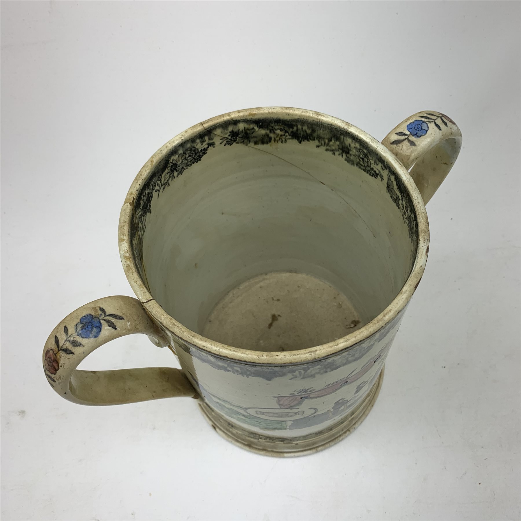 A large 19th century Staffordshire loving cup, detailed 'The Real Cabinet of Friendship Justice and Equity' (a/f), H22cm, together with a pair of 19th century Staffordshire dalmatians, upon oval blue bases, H13cm, a Dresden ewer hand painted with floral sprays, with mark beneath, H15.5cm, and a Coalbrookdale style floral encrusted vase and cover, H16.5cm. 