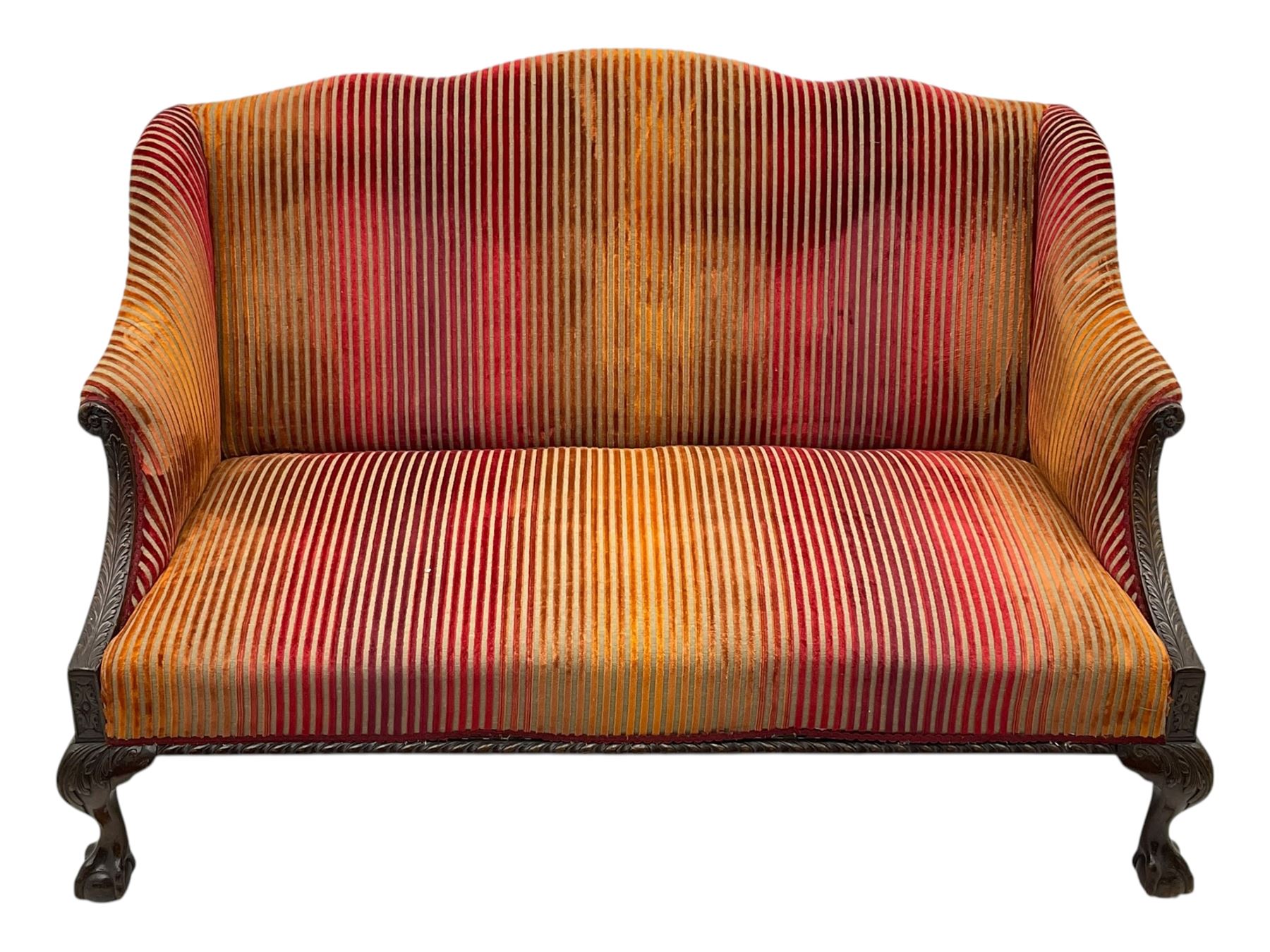 Mid-19th century mahogany two-seat sofa, upholstered in striped velvet fabric, the shaped backrest leading to outward-curved arms, carved apron with scrolling foliate details, raised on cabriole supports terminating in claw and ball feet