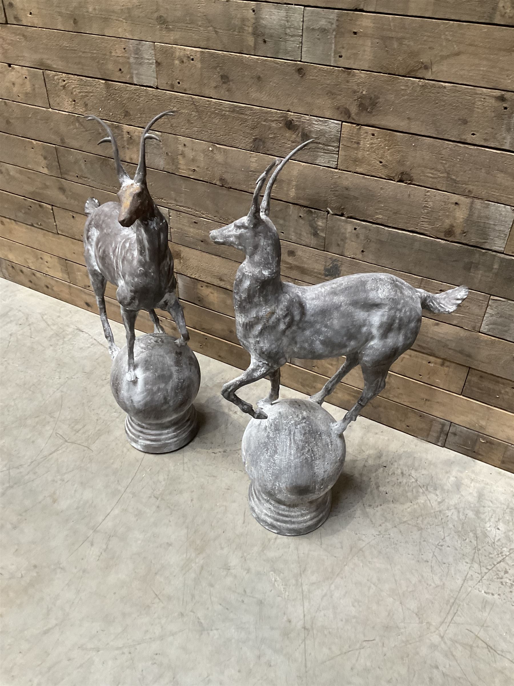 Pair of cast iron garden Stag figures or gate finials, raised on spherical ribbed base 