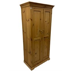 Solid pine double wardrobe, fitted with two panelled doors