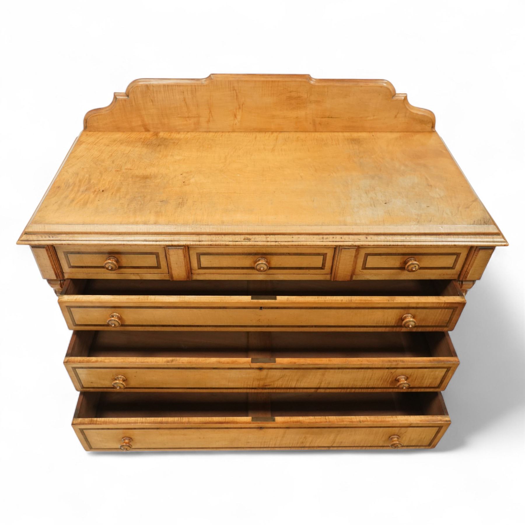 William Snowdon of Rochdale (fl.1876-1886) - Victorian sycamore chest of drawers, rectangular top with shaped gallery back above an arrangement of three short and three long drawers, each with moulded borders and turned wooden pulls, flanked by carved upright corbels, on a plinth base (99cm height including gallery)