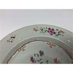 Three 18th century Chinese Famille Rose plates, the first example enamelled with blossoming peonies, rockwork and fence, the other two examples of similar design, decorated with blossoming peonies and sprigs within shaped inner borders, each approximately D23cm