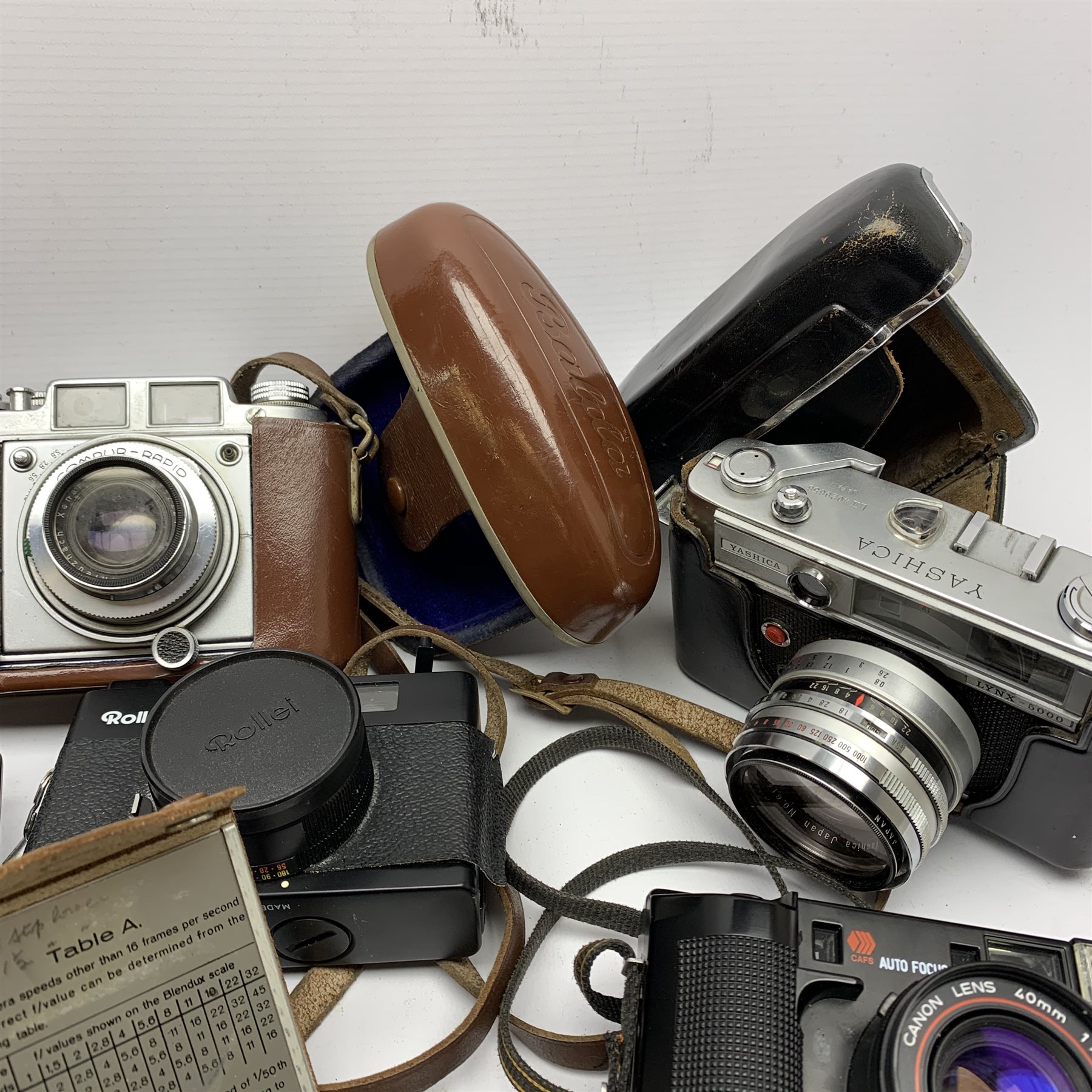Collection of cameras to include: Polaroid 600 Land Camera SLR 680 with auto focus/auto strobe, Rollei XF 35, Canon ML AF35, Fuji TW-300, Balda Baldina Compur-Rapid, YASHICA LYNX-5000, Canon Canonet QL19, flash bar and two light meters in one box