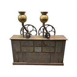 Cabinet with multiple drawers and cupboards mounted with two industrial coffee grinders with large flywheels and brass coffee reservoirs, early 20th century 