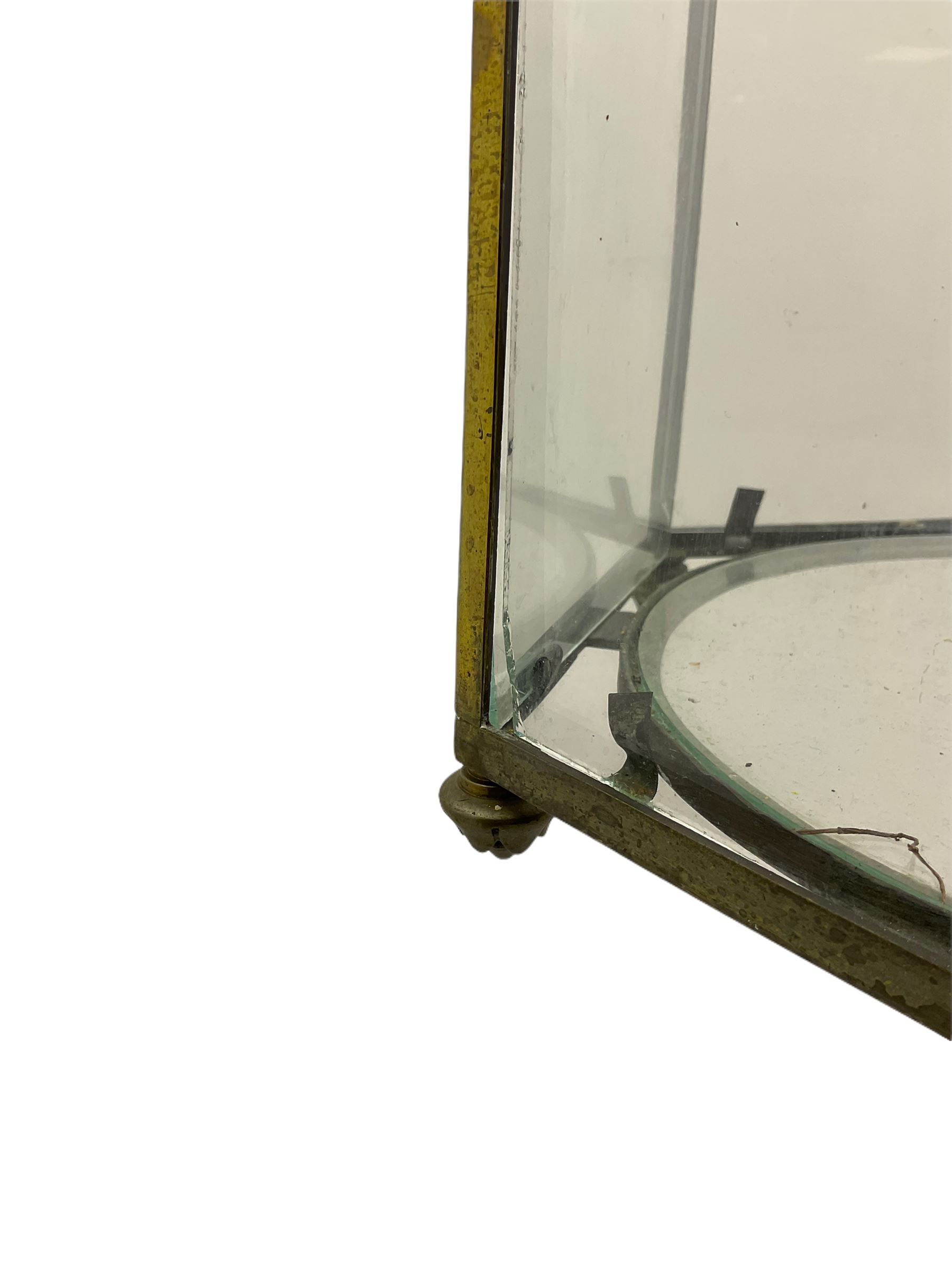 19th century brass and clear glass hexagonal hall lantern, with scrolling wire work open domed top over six arched panels, including a hinged door, the base enclosed with a circular glass panel on turned feet, H64cm