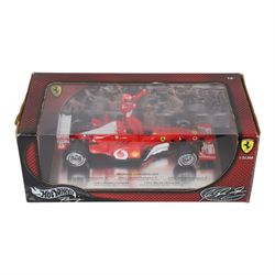 Signed Michael Schumacher Hot Wheels Ferrari 1:18 scale model, 2002 five-times World Champion edition depicting Schumacher sitting on the side of his car with arms raised, with his signature in black marker to wing of car, boxed