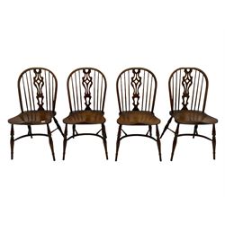 Four medium elm Windsor chairs, high comb back with shaped splat, saddle seat