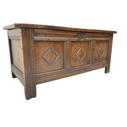 18th century oak chest or coffer, rectangular hinged top over moulded frieze rail, the three panel front carved with lozenges, raised on stile supports