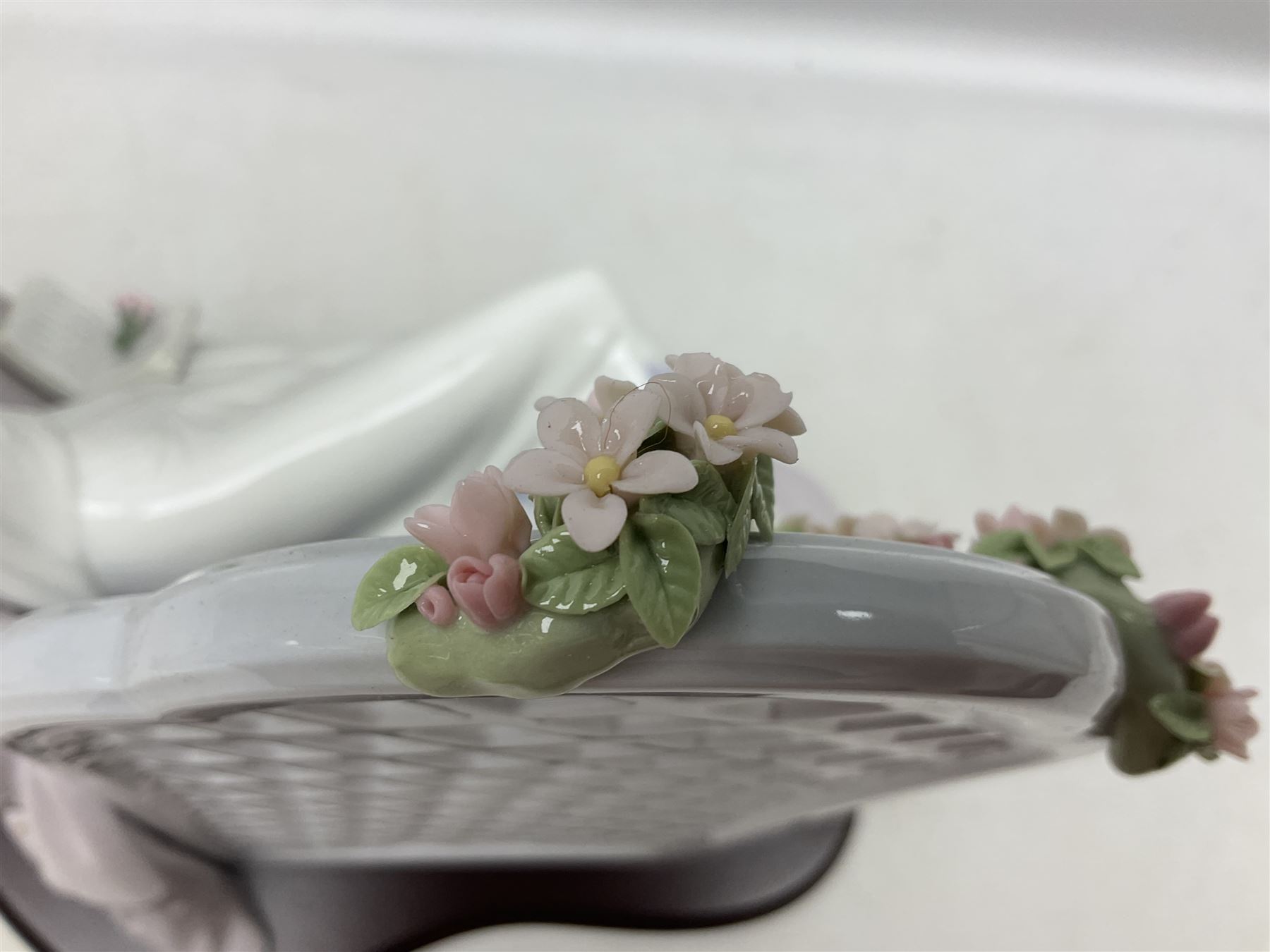 Lladro figure, Garden of Dreams, modelled as a woman reclining in front of trellis of flowers on a mahogany base, limited edition 3129/4000, sculpted by  José Puche, with original box, no 7634, year issued 1994, year retired 1996, H32cm