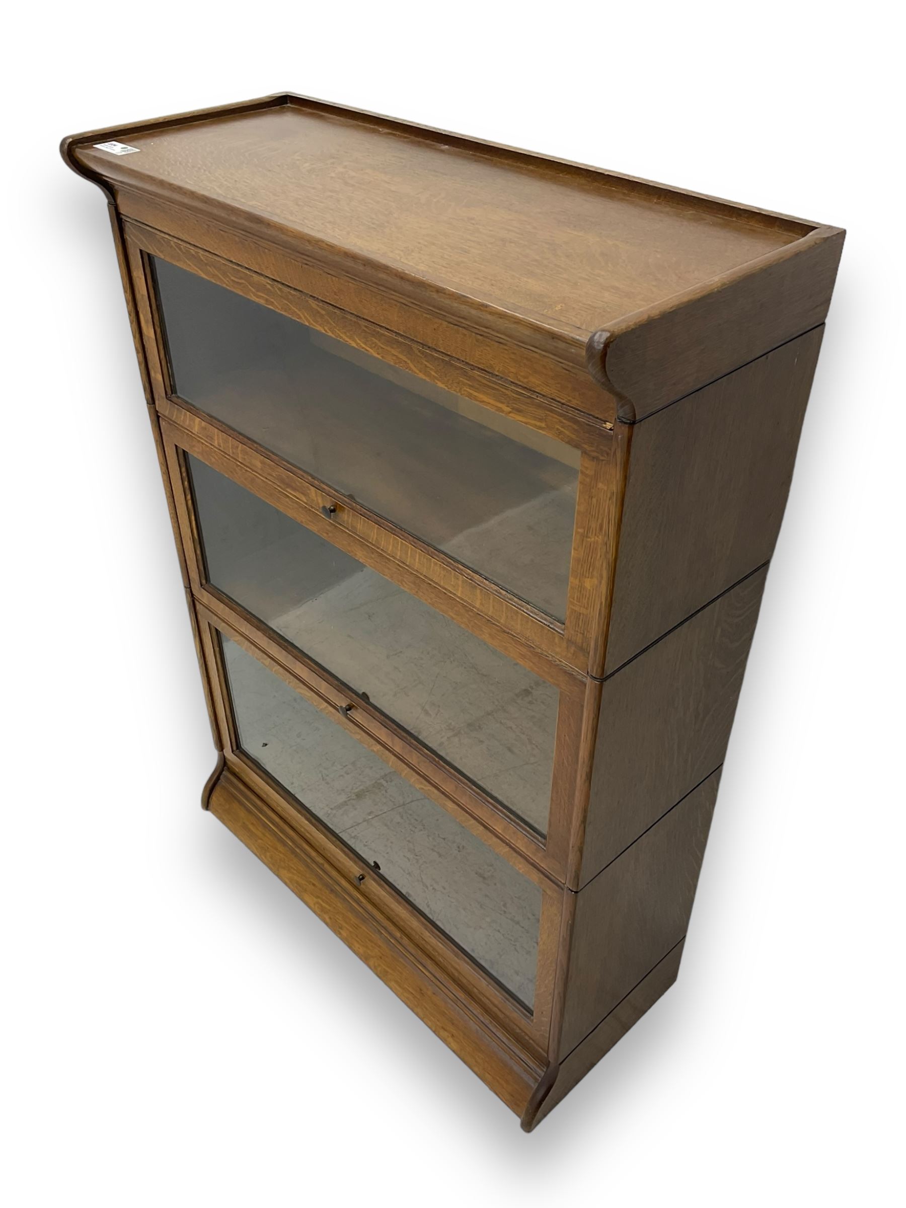 Early 20th century oak three-tier stacking library bookcase, enclosed by hinged and sliding glazed doors