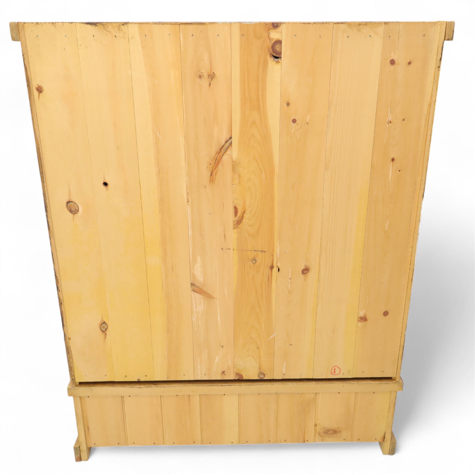 Contemporary pine hanging wardrobe, twin panelled doors enclosing open hanging space with brass rail, two drawers to lower section, on moulded plinth base