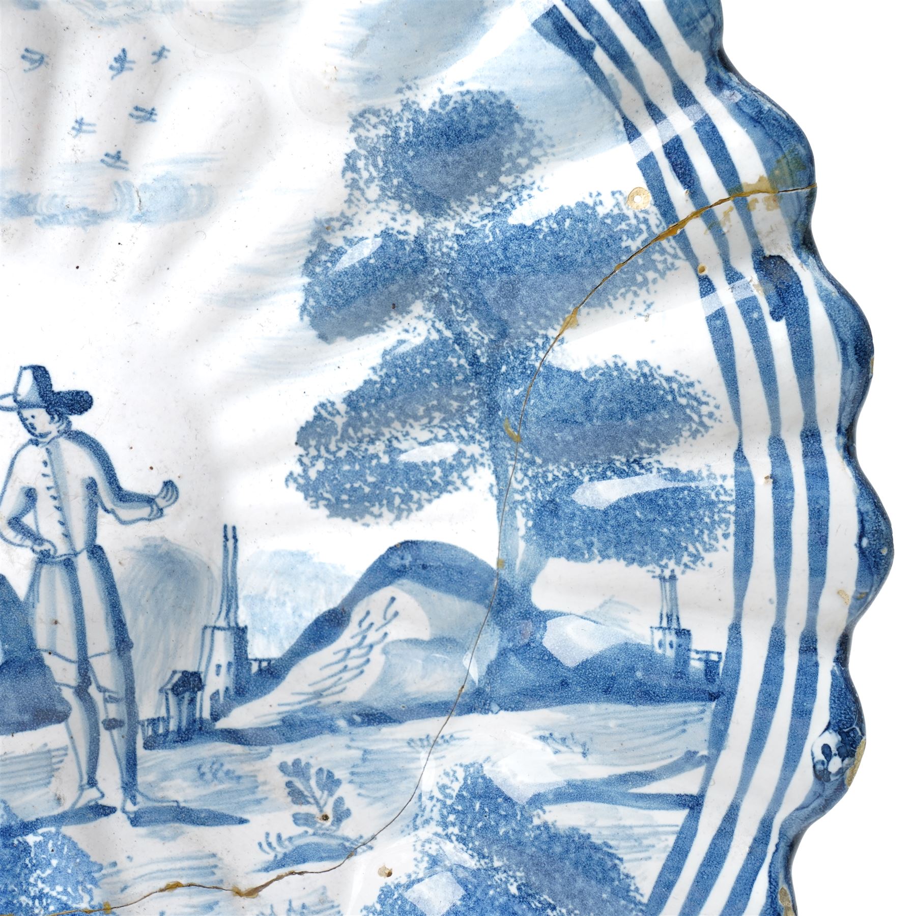 18th century Dutch Delft plate of fluted design decorated in blue and white with figures in a landscape D29cm and a Dutch Delft vase decorated in blue and white with oriental flowers H21cm (2)