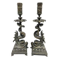 Pair of late 19th/ early 20th century brass candlesticks in the form of dolphins upon a stepped base with Fleur-de-lis design, H32cm 