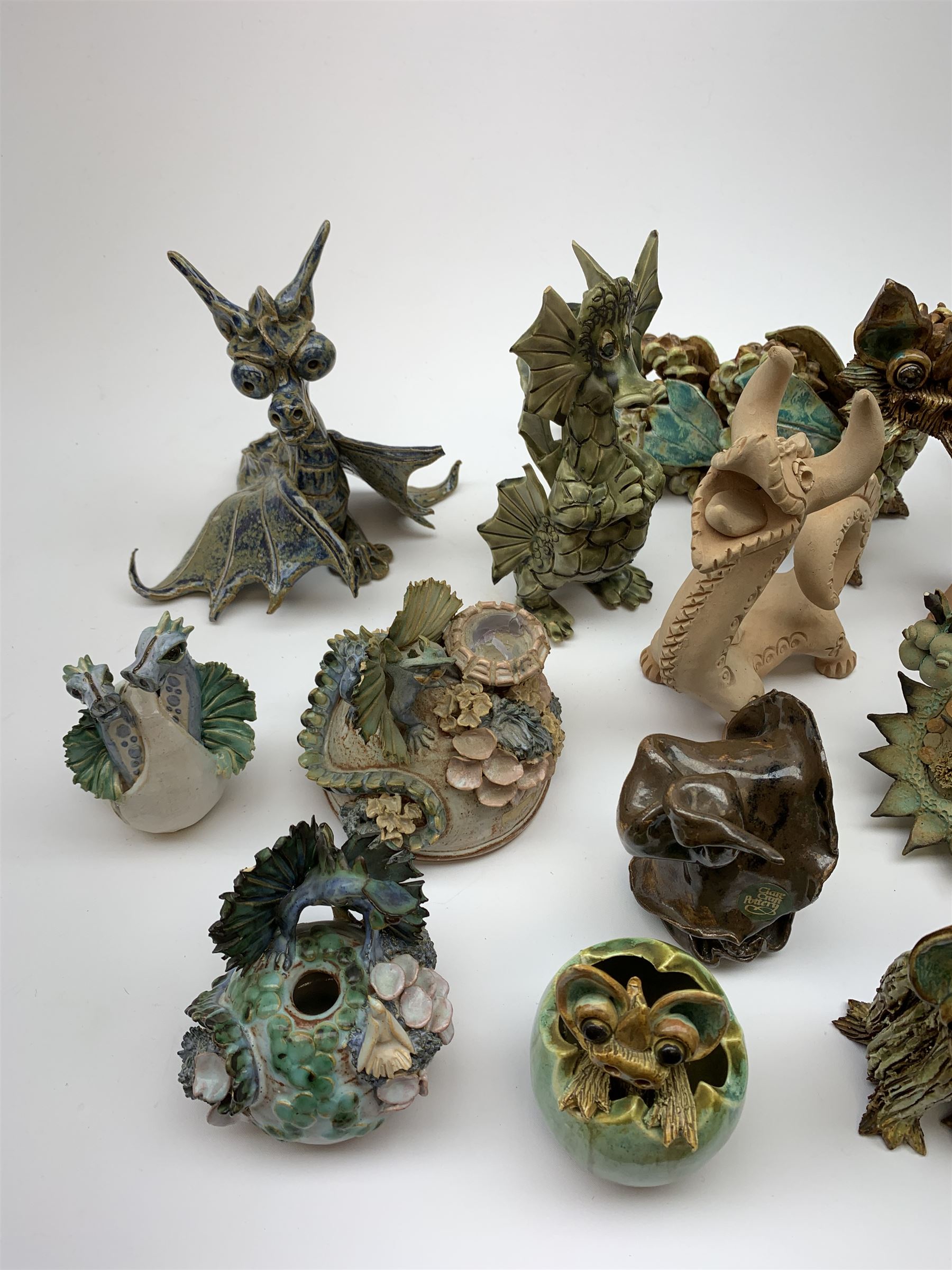 Four Cheval Ceramics figures modelled as ponies, together with a number of studio pottery figures of dragons. 