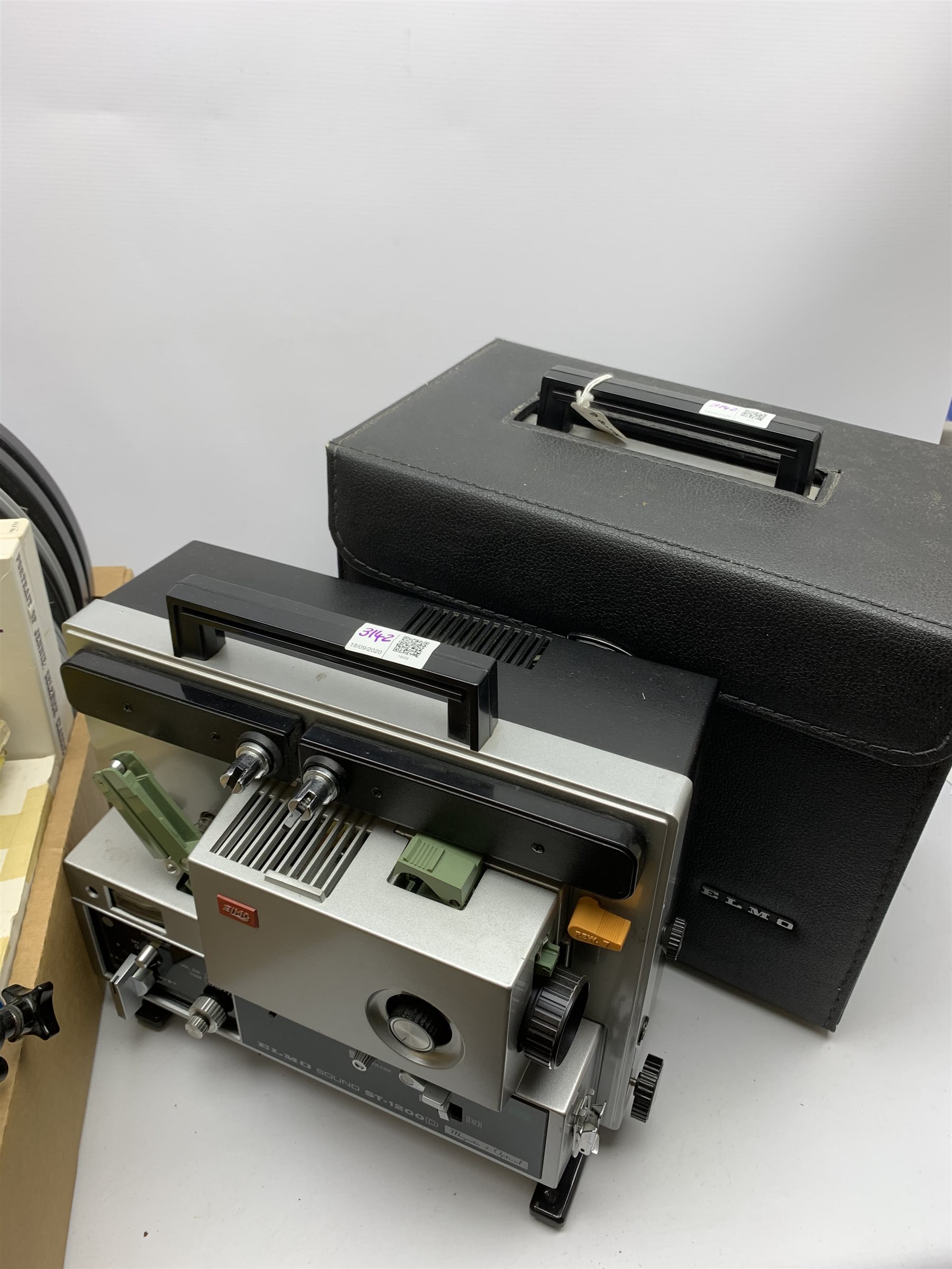 Two 'ELMO Sound ST-1200D' super 8 sound projectors, one in a carry case with photocopy of the original instruction manual, together with various film reels, spare bulbs and other accessories